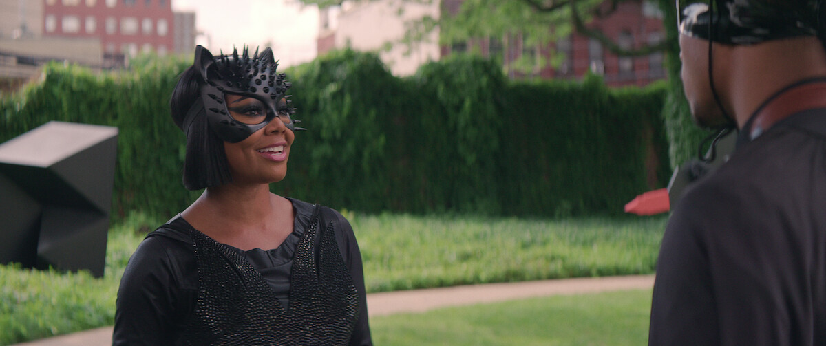 Gabrielle Union wears a black catsuit and half mask in a still from ‘The Perfect Find.’