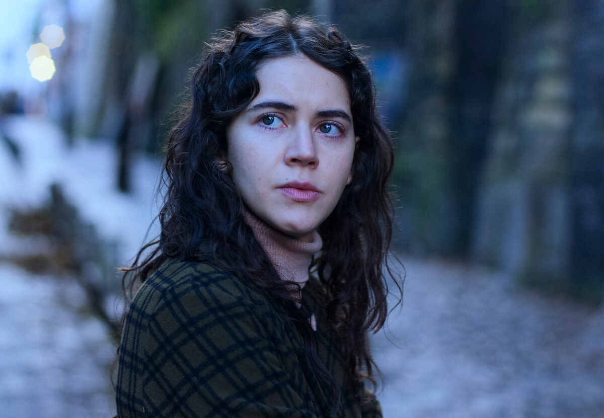 Tessa Ia as Valeria gazes across the street in ‘No One Saw Us Leave.’