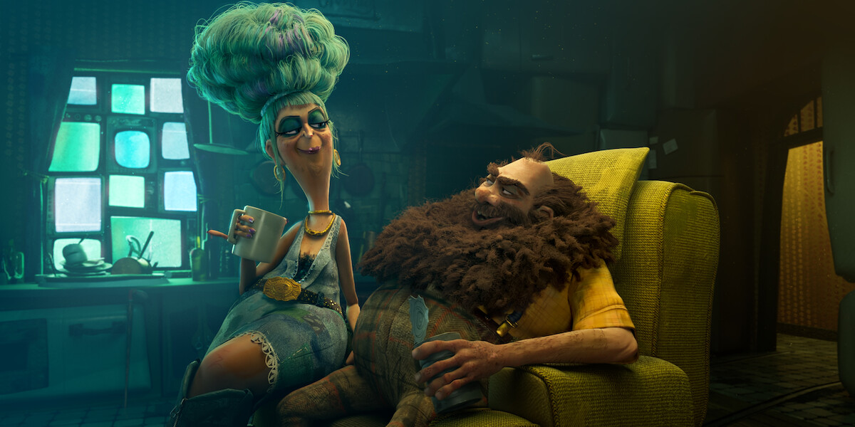 In an image from ‘The Twits,’ Margo Martindale (as the voice of Credenza Twit) sits on the arm of a chair as Johnny Vegas (as the voice of Jim Twit) sits down.
