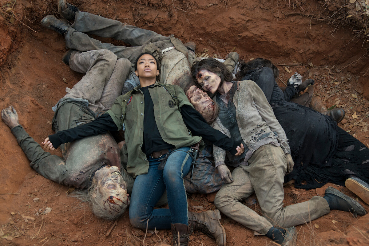 Sasha (Sonequa Martin-Green) despondently lies down in a mass grave of walker bodies