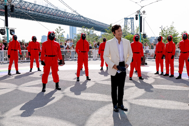 Lee Byung-hun stands with Pink Guards at a 'Squid Game' Season 3 event at Domino Park in Brooklyn, New York.