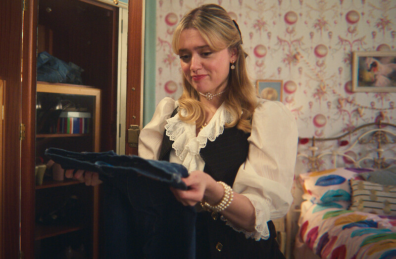 woman holding a pair of jeans