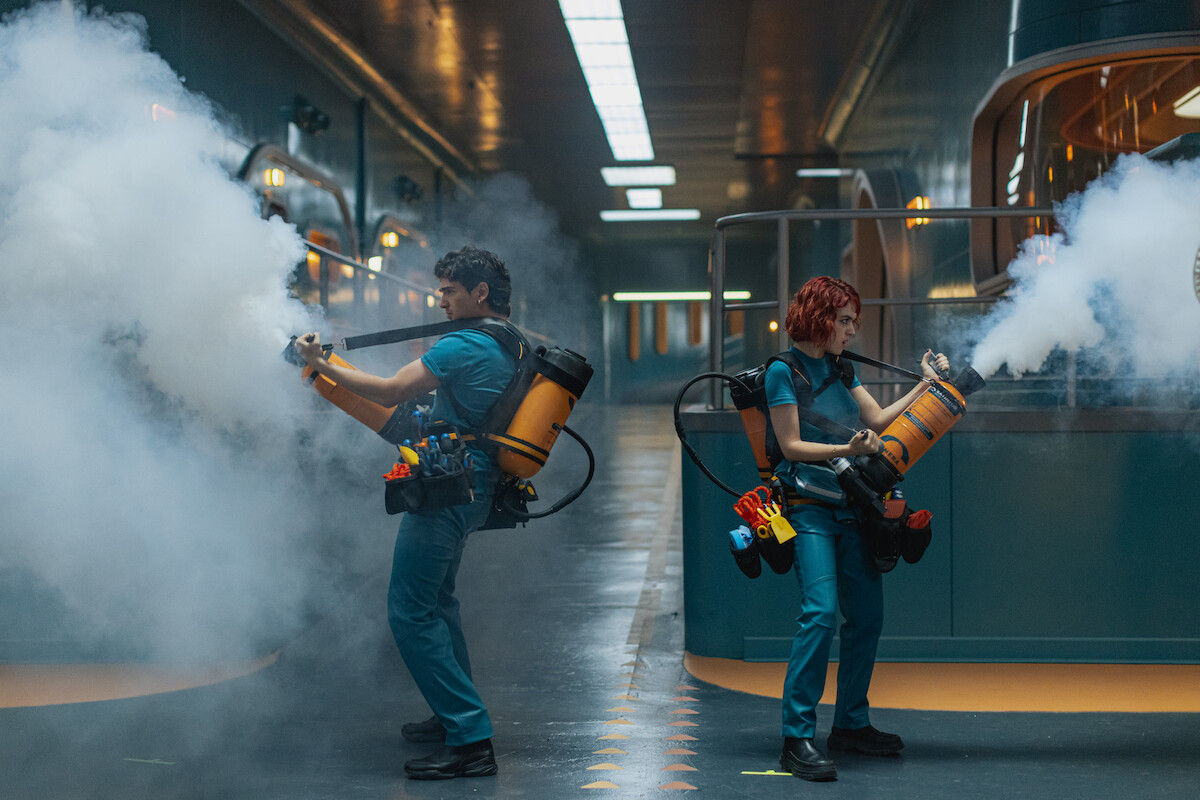 Pau Simon as Max and Alicia Falcó as Asia create a distraction with smoke in a production still of ‘Billionaire’s Bunker’.