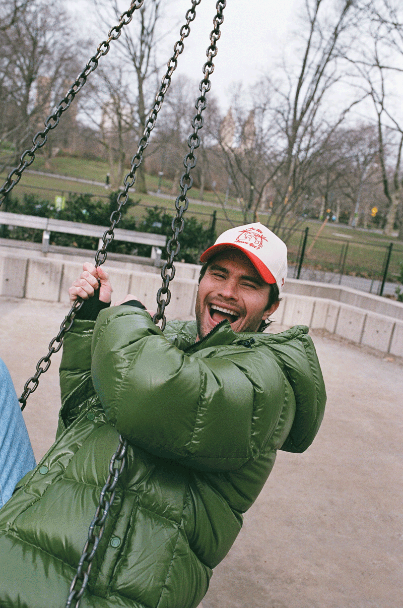 Chase Stokes in Central Park on tire swing.