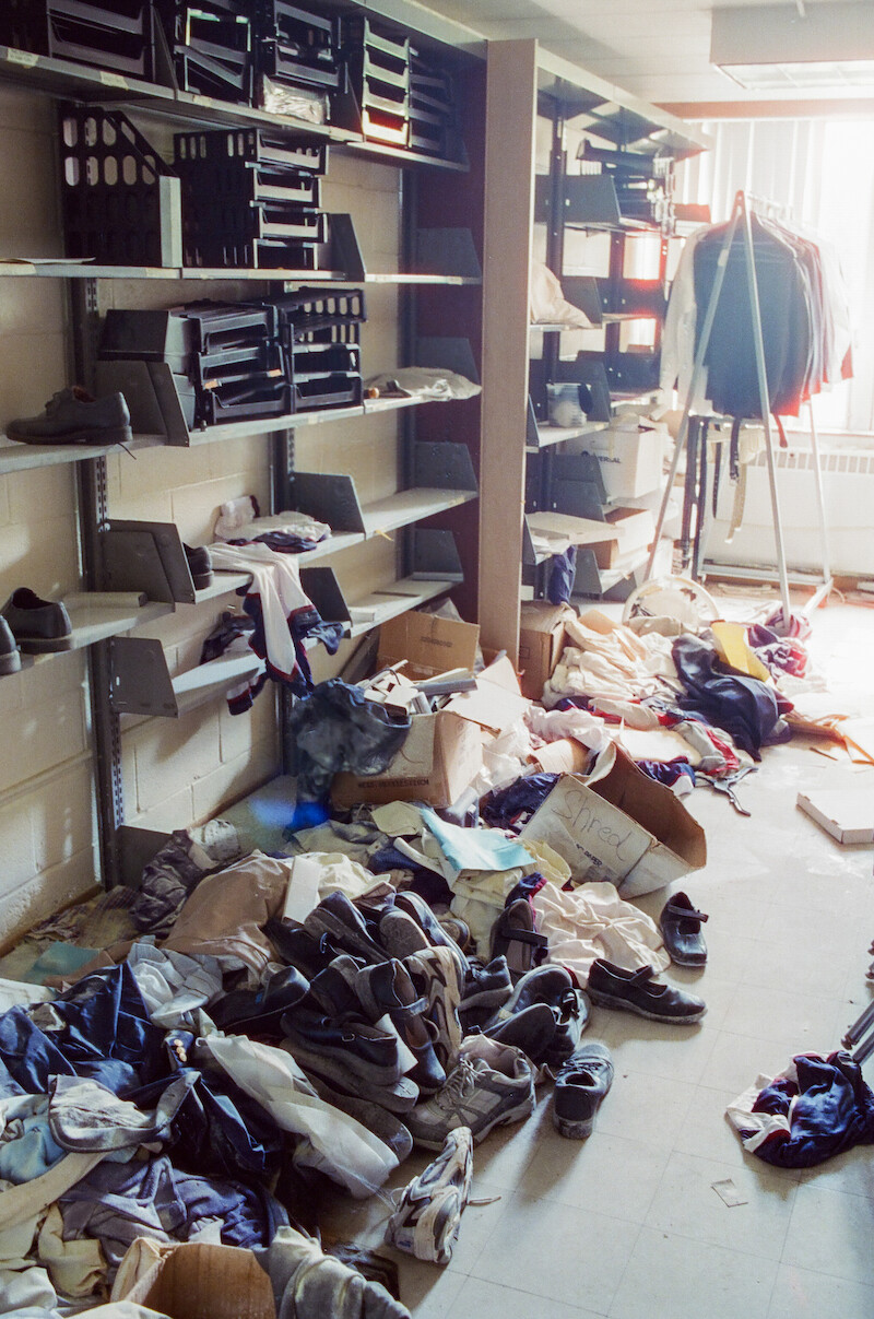 Abandoned piles of clothes and shoes in a room at Ivy Ridge. 