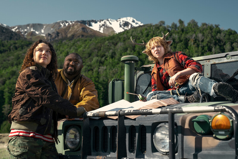  Stefania LaVie Owen as Becky, Nonso Anozie as Jepperd, and Christian Convery as Gus look up together in a mountainous landscape in Season 3 of 'Sweet Tooth'