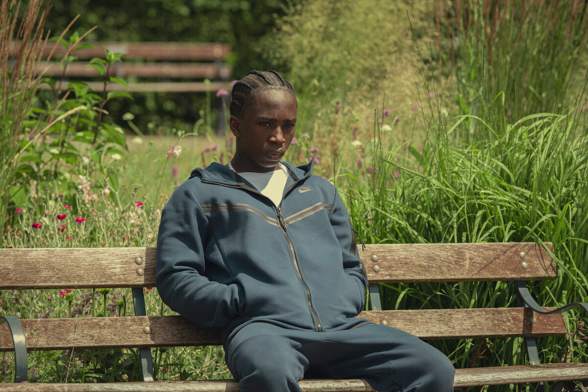 Araloyin Oshunremi as Stefan sits on a bench in Season 3 of ‘Top Boy.’