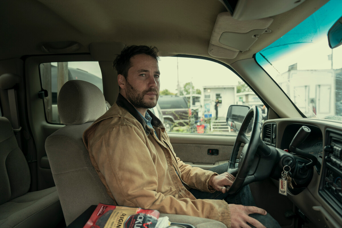 Taylor Kitsch as Glen Kryger sits in his car in Season 1 of ‘Painkiller.’