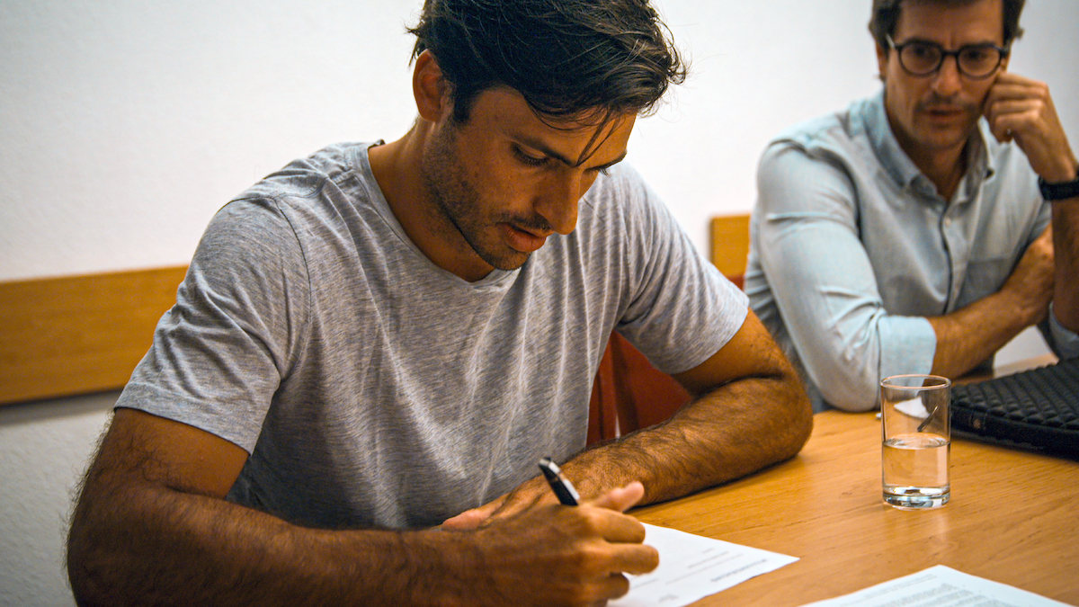 Carlos Sainz signs a contract.