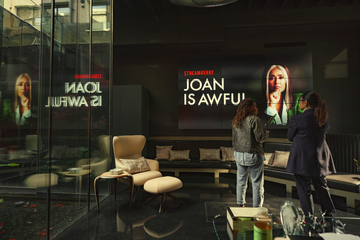 Two women look at a television screen in an office in Season 6 of Black Mirror.