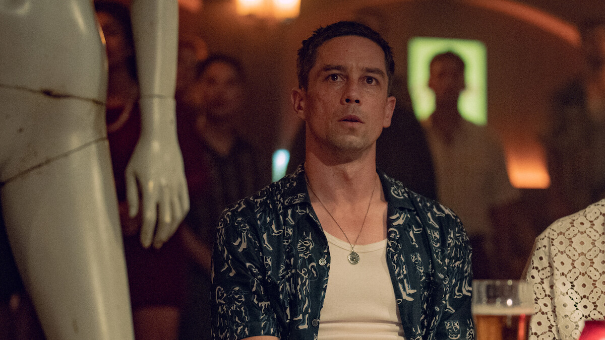 Killian Scott as Orpheus sits beside a mannequin in Season 1 of ‘Kaos’