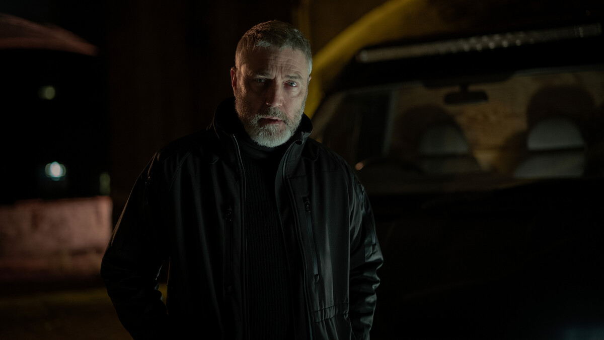 Dennis McCabe in a dark setting