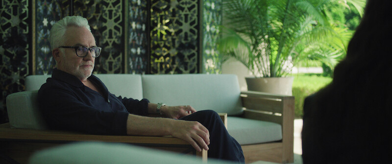 Bradley Whitford as Stu Magnusson sits on a chair in Season 1 of 'The Madness'