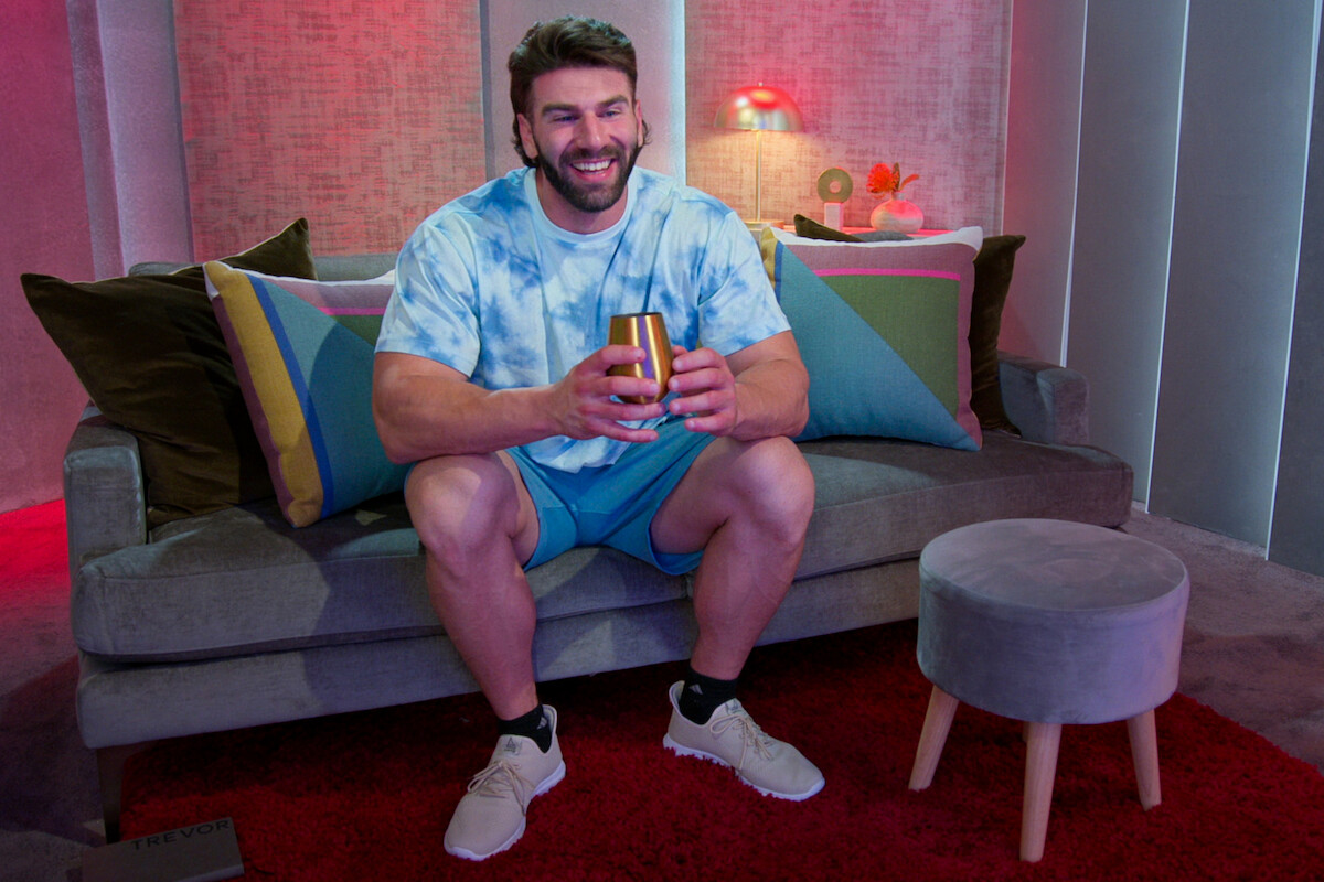 Trevor wears a blue tie-dye tee shirt and smiles in season 6 of ‘Love Is Blind’