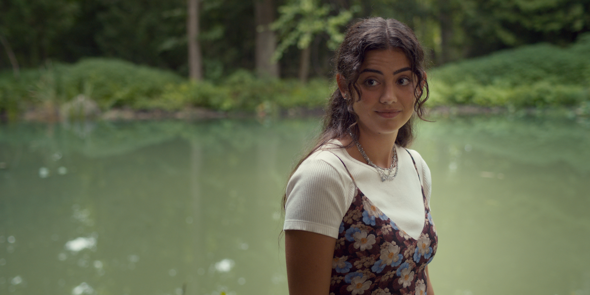 Sadie Laflamme-Snow as Alice stands in front of a pond in a production still from ‘The Way Home.’