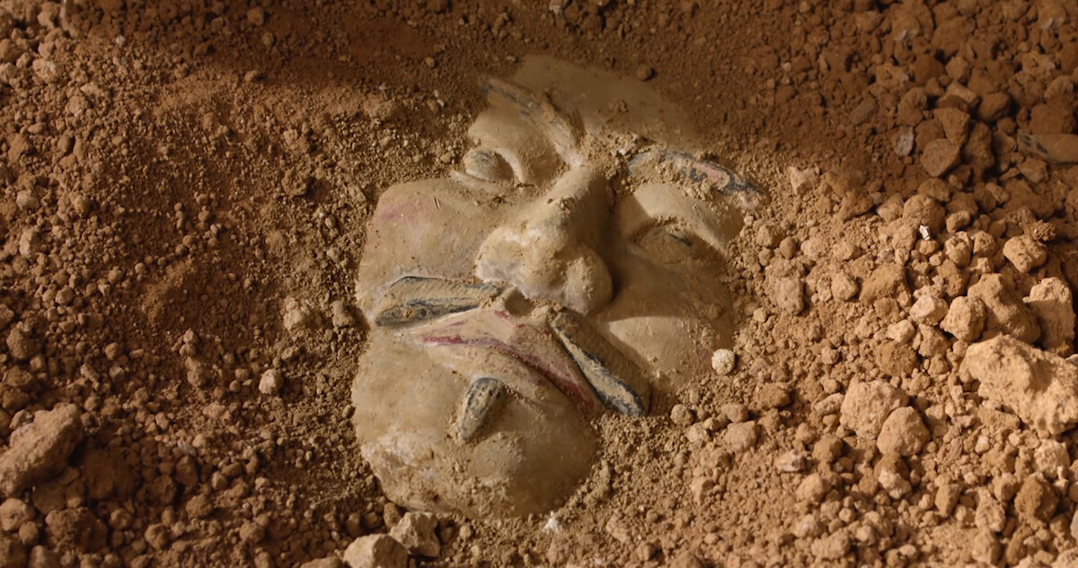 A Terracotta Warrior buried in the dirt.