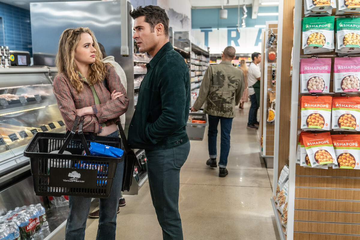 Joey King as Zara Ford recoils at Zac Efron as Chris Cole in ‘A Family Affair.’
