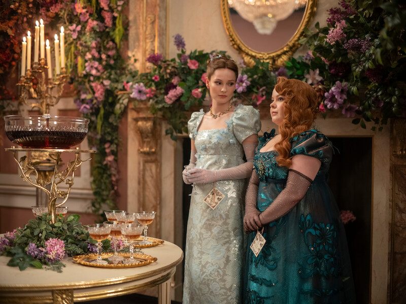 Hannah Dodd as Francesca Bridgerton and Nicola Coughlan as Penelope Featherington stand at a ball together in Season 3 of 'Bridgerton'