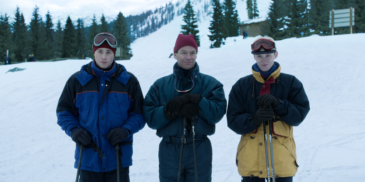 Prince William, Prince Charles and Prince Harry standing on a mountain in snow suits in ‘The Crown.’