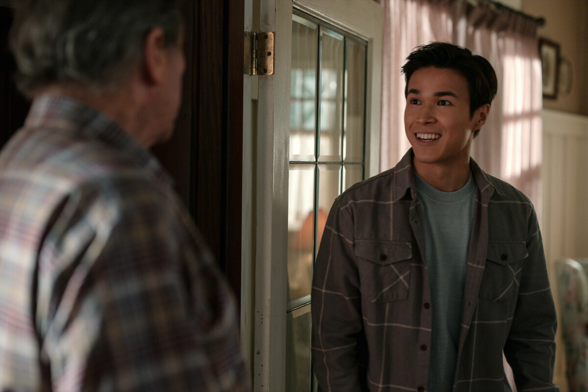 Kai Bradbury as Denny smiles wearing a gray flannel shirt in Season 4 of ‘Virgin River.’