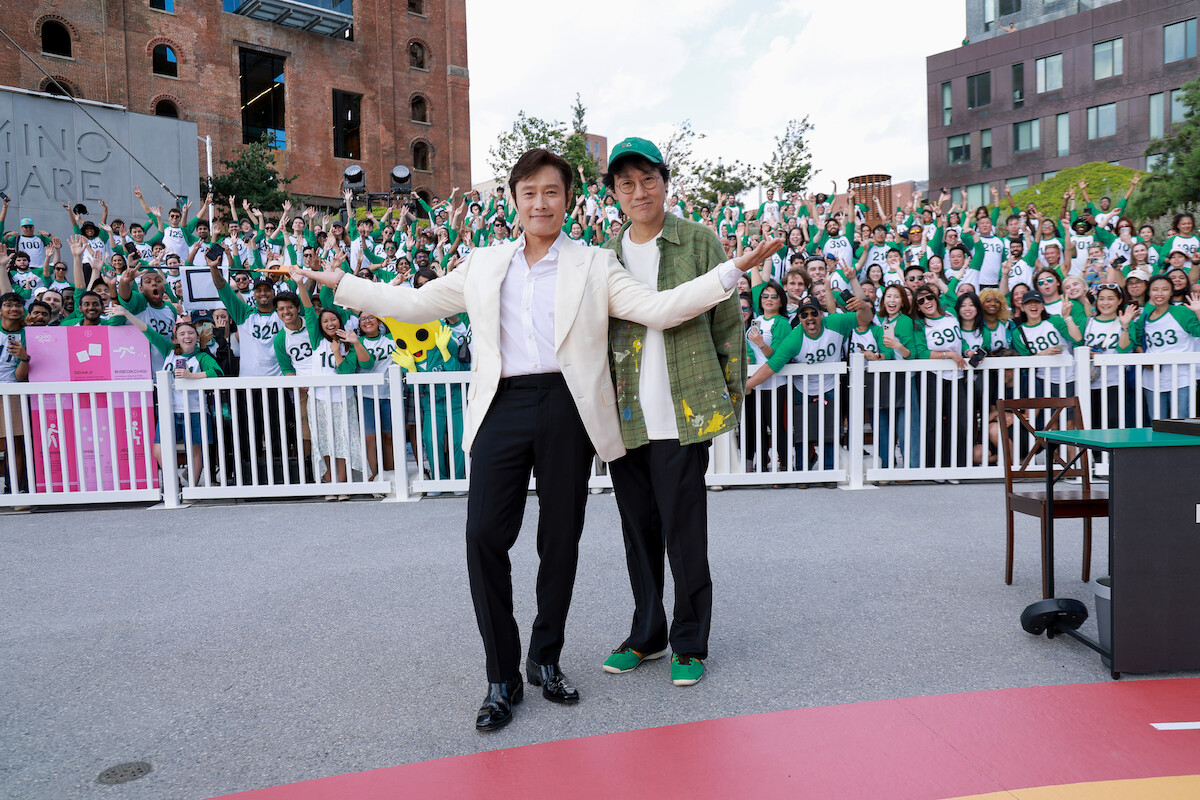 Lee Byung-hun and Hwang Dong-hyuk in front of a crowd of fans at a ‘Squid Game’ Season 3 fan event in Brooklyn, New York.