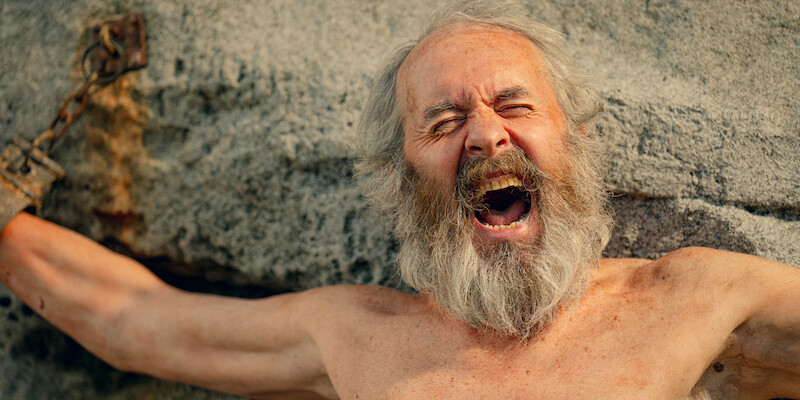Stephen Dillane as Prometheus screams with his hands bound to a rock in 'KAOS'