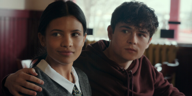 Nikki Rodriguez as Jackie and Ashby Gentry as Alex sit at a restaurant booth together in Season 1 of ‘My Life with the Walter Boys.’