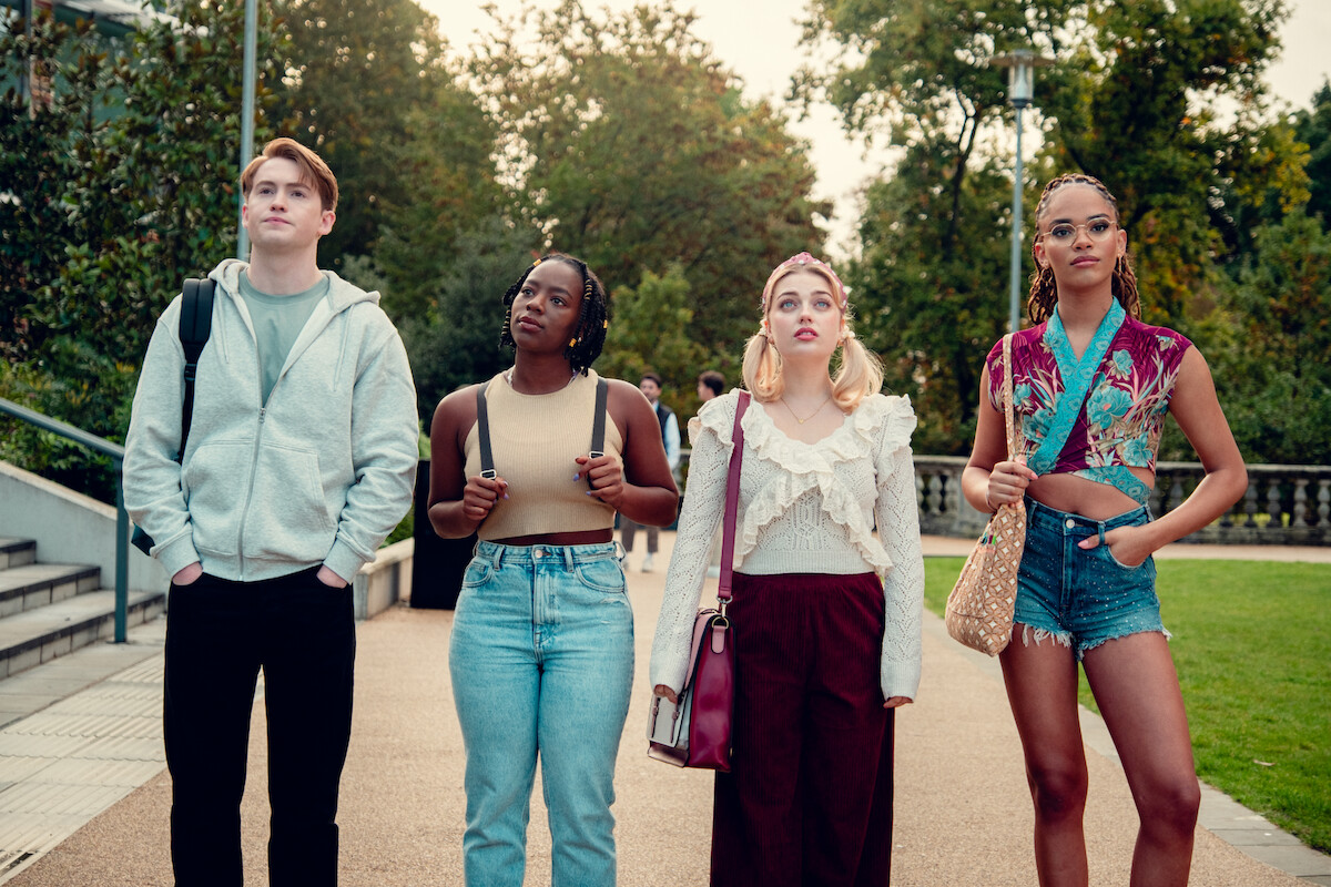 Kit Connor as Nick, Corrina Brown as Tara, Rhea Norwood as Imogen, and Yasmin Finney as Elle stand together on a university campus looking off into the distance in Season 3 of ‘Heartstopper.’