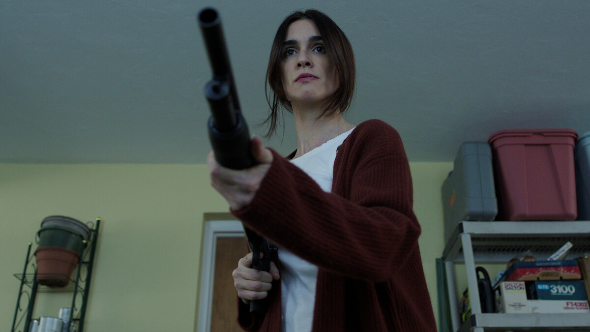 A character holding a shotgun on someone off screen.