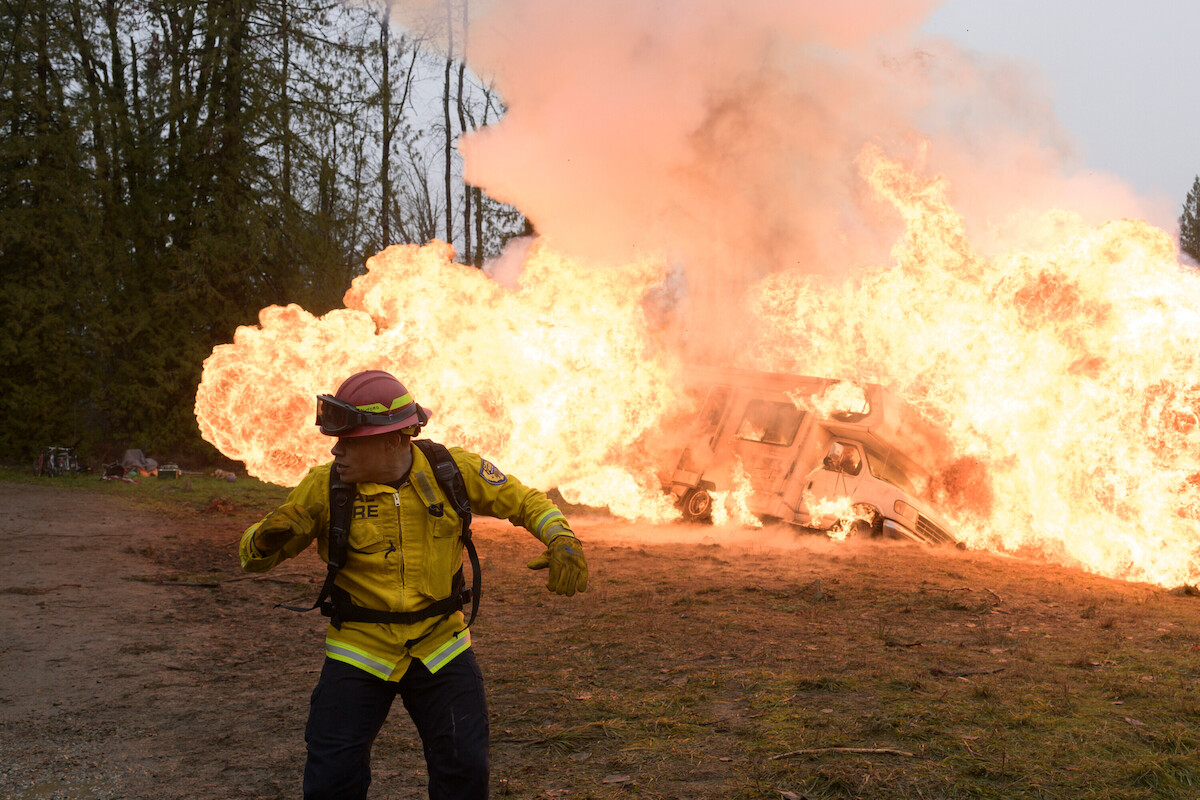 Jordan Calloway as firefighter Jake Crawford runs from an RV explosion.