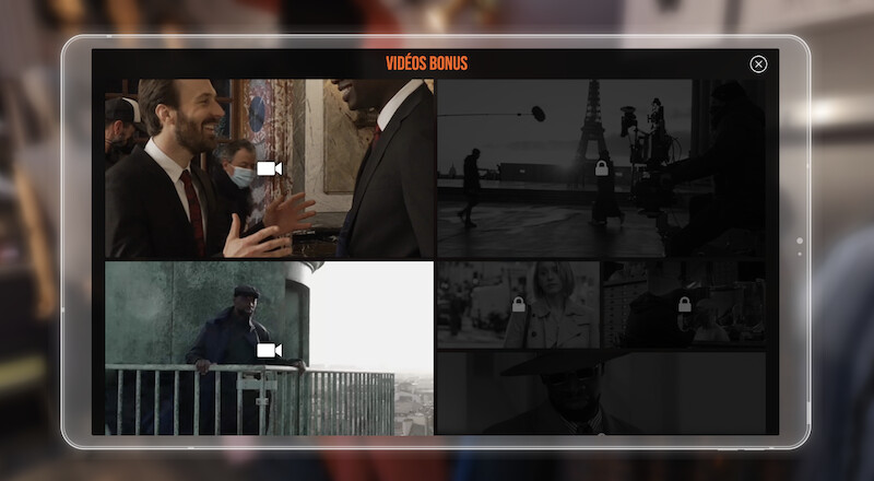 A monitor shows several video thumbnails in 'Lupin Experience' 