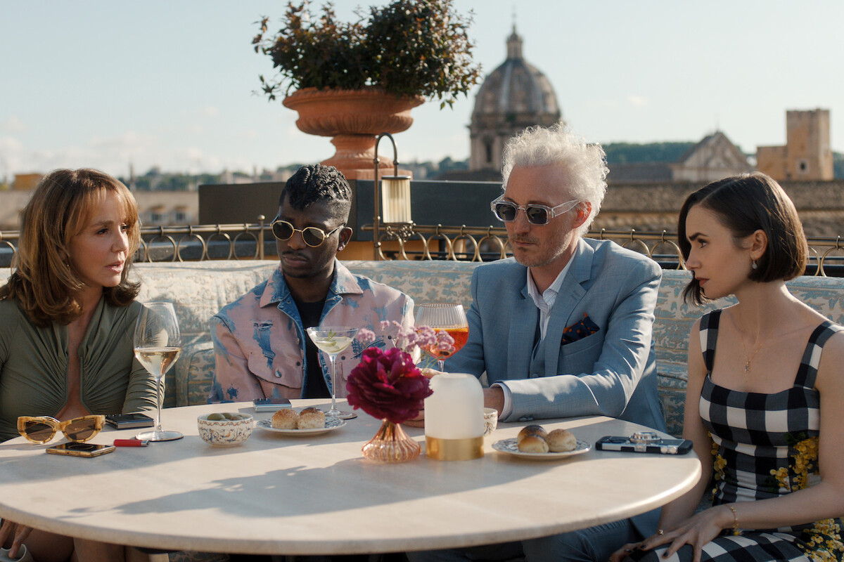 Philippine Leroy-Beaulieu as Sylvie Grateau, Samuel Arnold as Julien, Bruno Gouery as Luc and Lily Collins as Emily in ‘Emily in Paris’ Season 5.