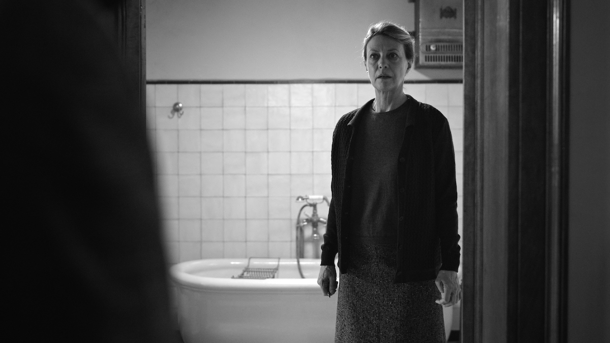 Margherita Buy as Signora Buffi stands in a bathroom with a fearful expression in ‘Ripley’