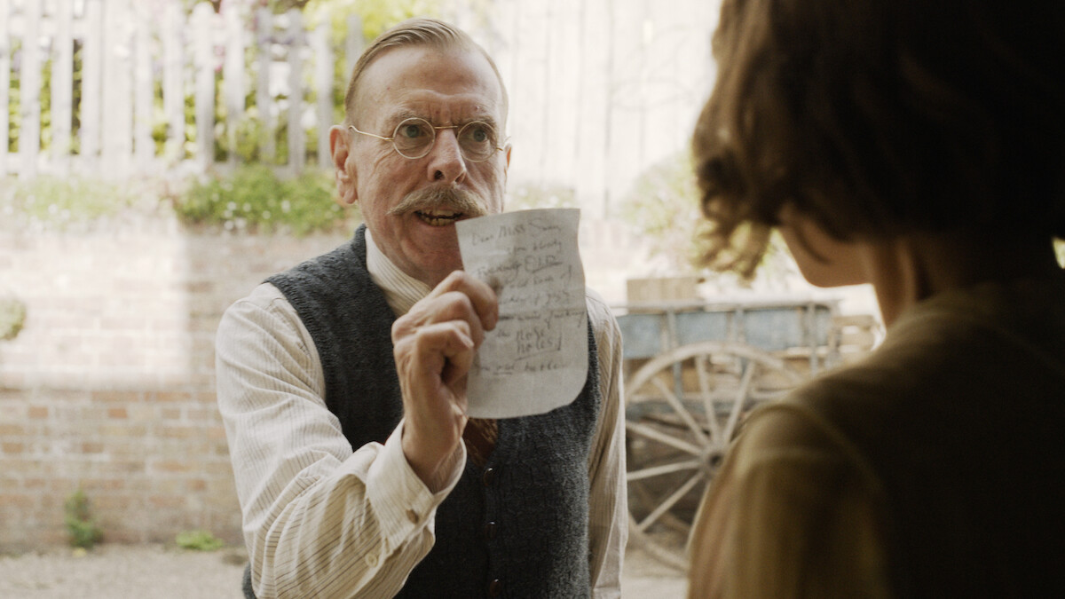 Timothy Spall as Edward Swan angrily shows a letter to Jessie Buckley as Rose Gooding in ‘Wicked Little Letters.’