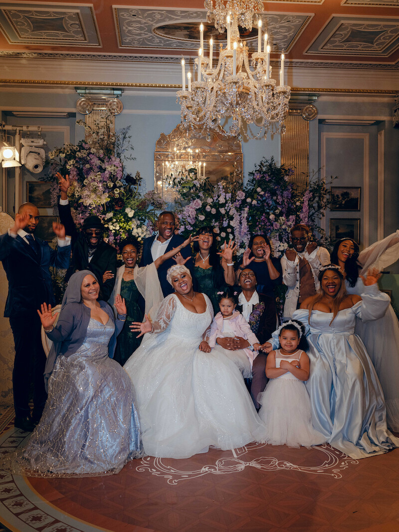 A group shot of the couple and guests in 'The Event of the Season: A Bridgerton Wedding'