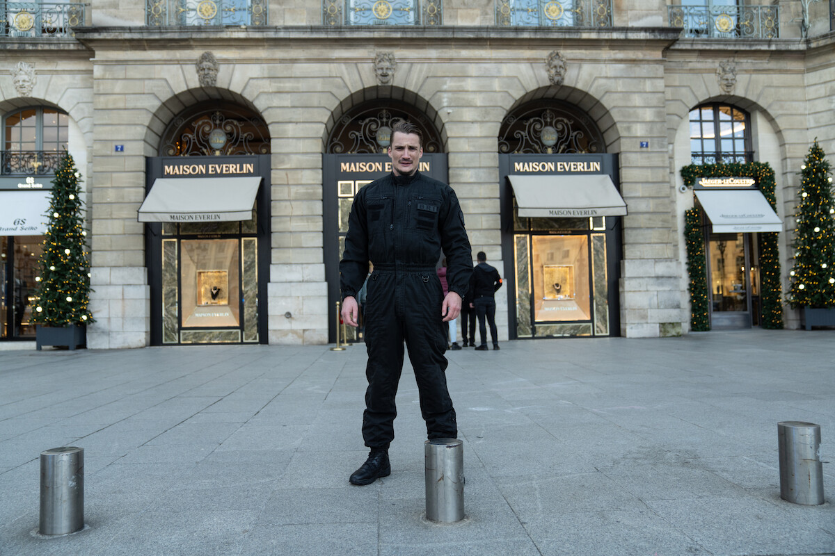 Pierre Lottin as Bruno (2021) stands on the street in Season 3 of ‘Lupin.’