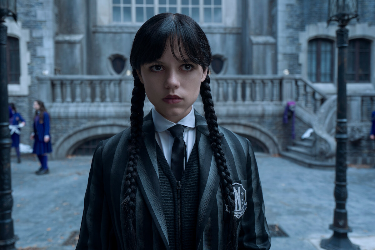 Jenna Ortega as Wednesday stands at Nevermore Academy in Season 2 of 'Wednesday'