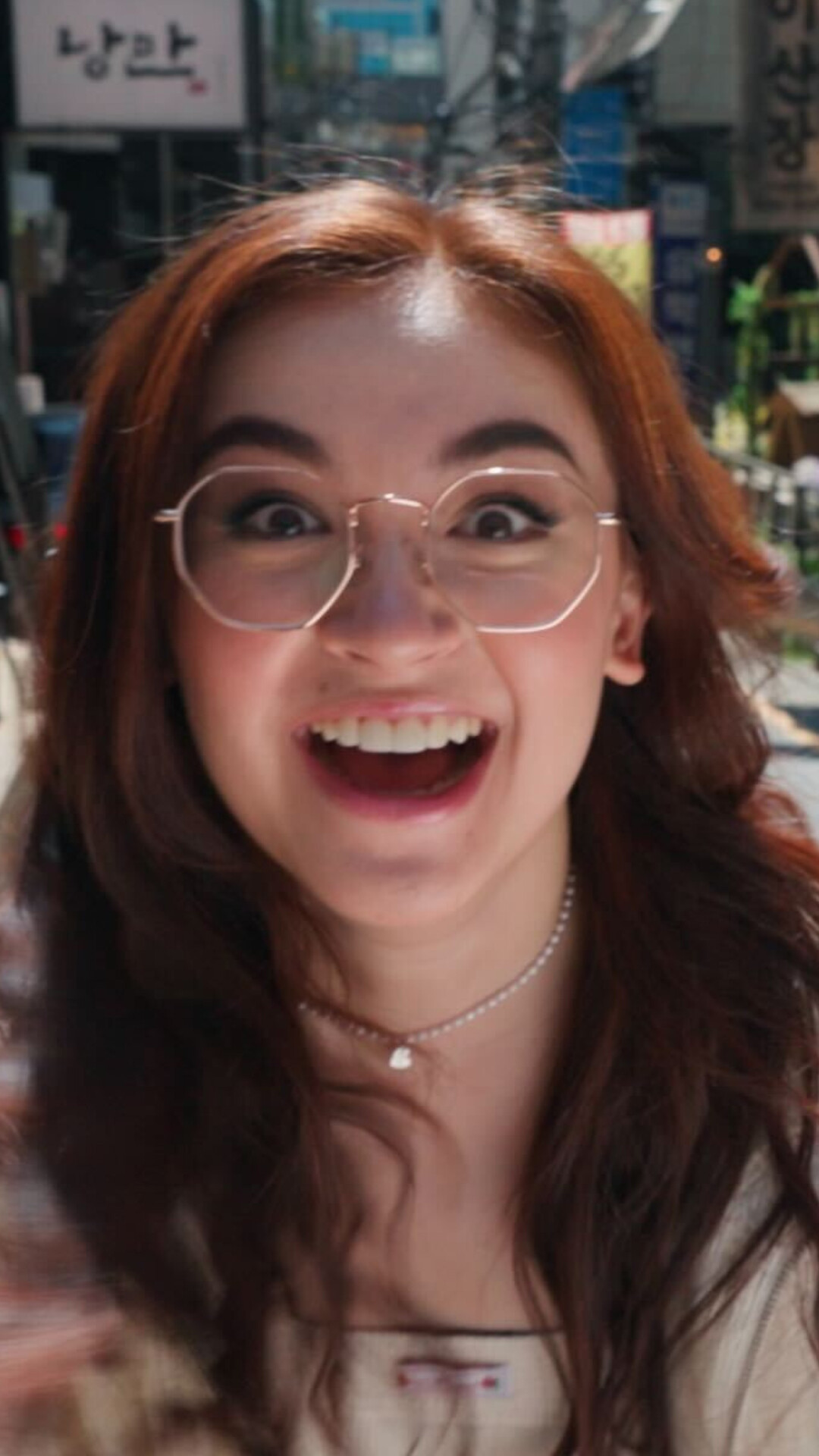 Anna Cathcart as Kitty Song Covey smiles widely.