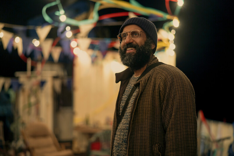Adeel Akhtar as Singh stands smiling in Season 3 of 'Sweet Tooth'
