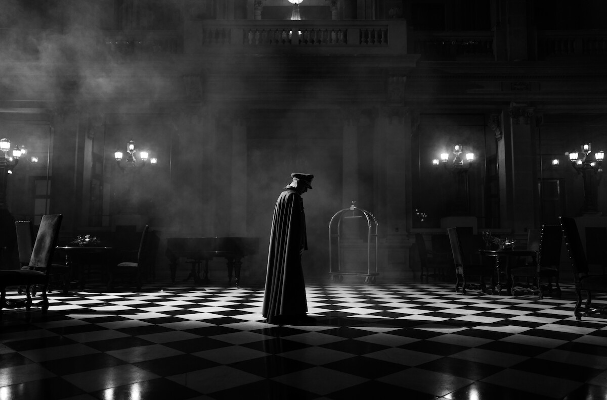 Man standing on a checkered floor