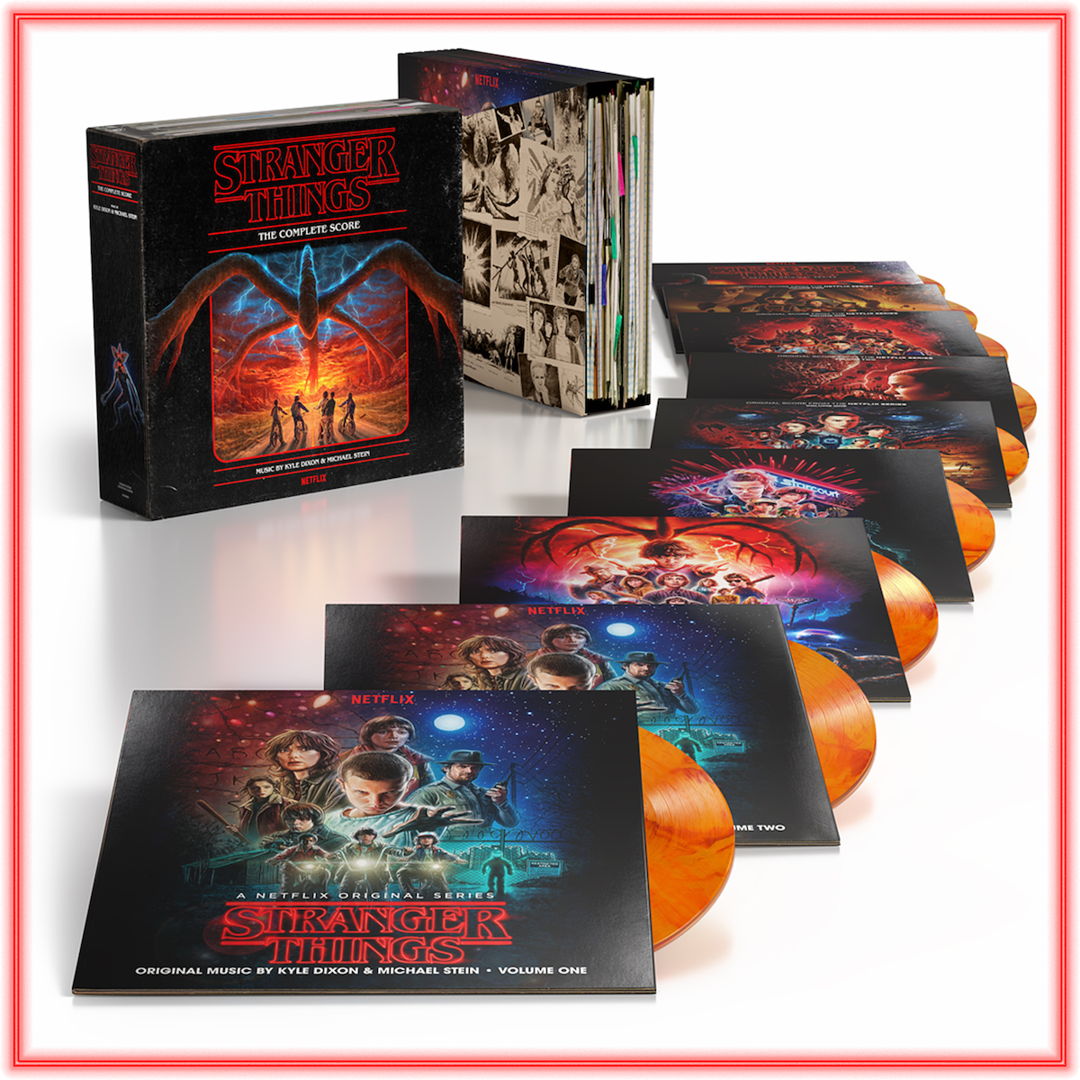 Stranger Things vinyl box set on display, showing multiple orange records and illustrated covers, all themed around the TV series. The box has striking artwork with characters and atmospheric graphics in a collector’s edition format.