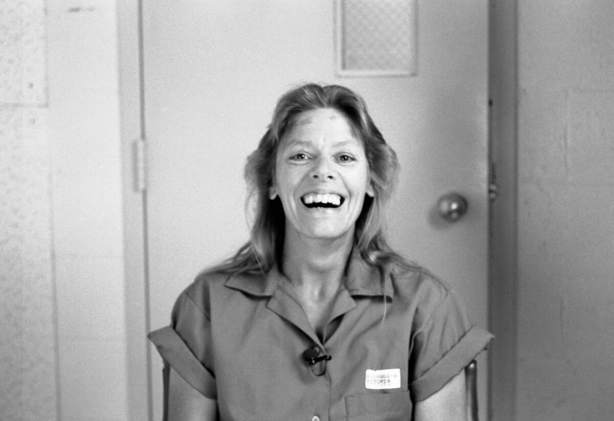 A smiling Aileen Wuornos sits down for an interview on death row.