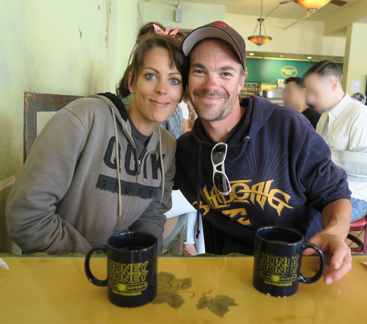 Amanda Antoni and Lee Antoni sit together smiling at a restaurant.