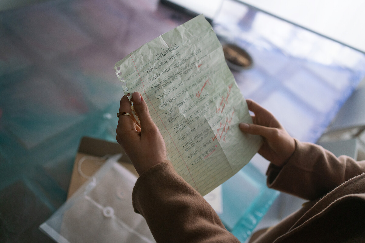 Sofia Carson as Alex holding a list of goals she wrote at 13 years old called ‘The Life List’.