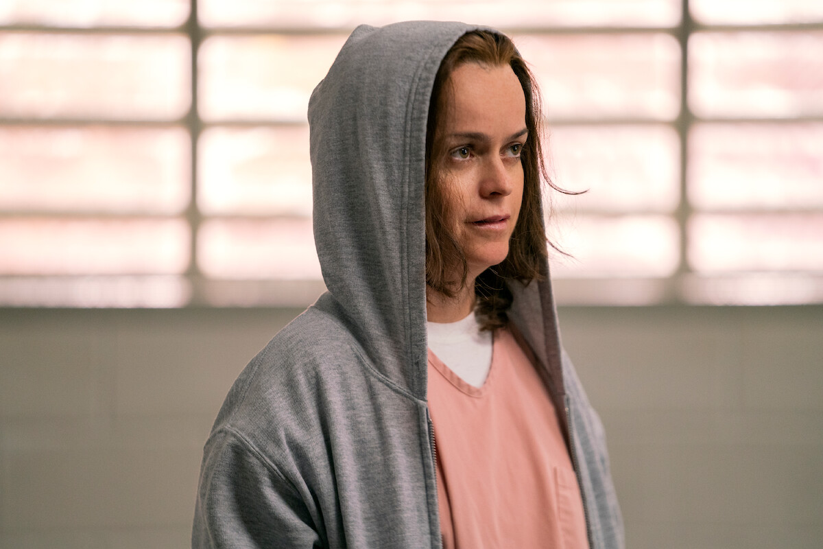 Taryn Manning as Pennsatucky wears a gray sweatshirt with the hood over her head in Season 7 of ‘Orange Is the New Black.’ 