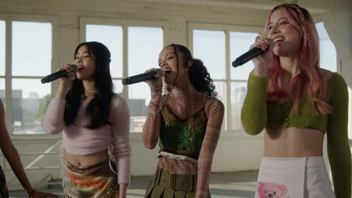 Sophia, Samara, and Celeste sing into microphones.