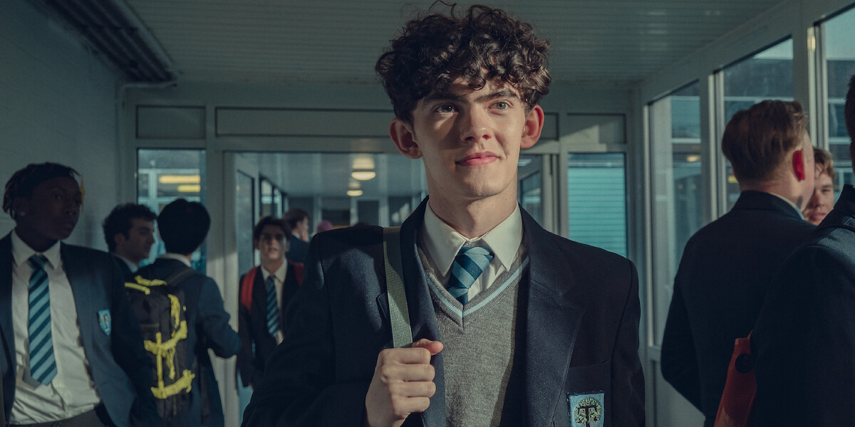 Joe Locke as Charlie stands in his school uniform in Season 2 of ‘Heartstopper.’ 