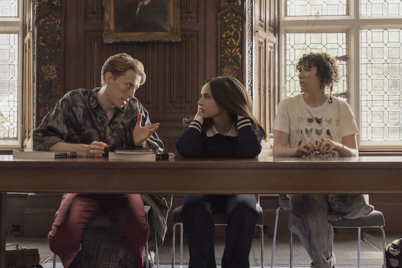Harry Trevaldwyn as Charlie, Sofia Carson as Anna, and Esmé Kingdom as Maggie talking in a classroom in 'My Oxford Year.'