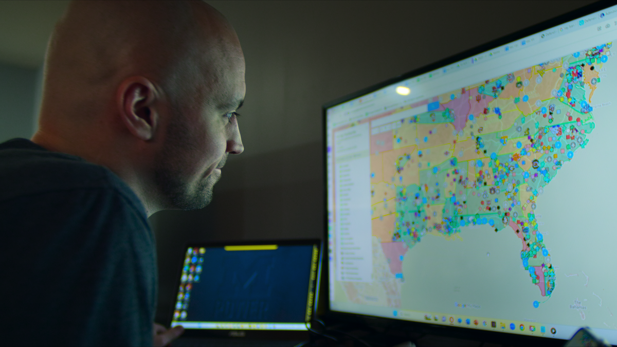 Connor Stalions looking at a map on his screen.