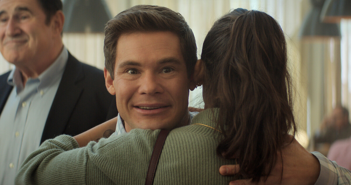 Adam Devine receiving a hug in 'The Out-Laws.'